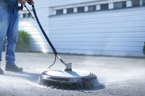 Professional power washing of concrete driveway and pavement surfaces